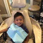 Happy young patient sitting at dental chair in Dunwoody Family & Cosmetic Dentistry.