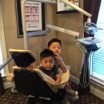 Two young boys sitting at dental chair.