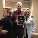 Dr. Angela Ojibway with her patient next to front desk office at Dunwoody Family & Cosmetic Dentistry.