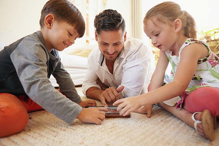 Father and children using digital tablet with free-wifi Dunwoody, GA