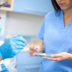 Dentists take dental filing which prepared his female assistant. Dunwoody, GA.