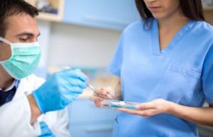 Dentists take dental filing which prepared his female assistant. Dunwoody, GA.