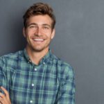 young handsome man in a checkered shirt smiling